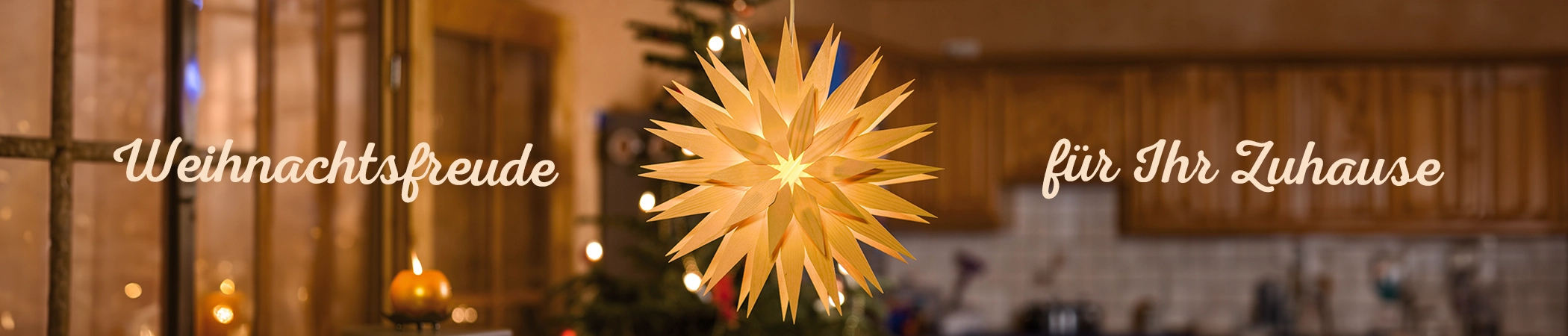 Ein leuchtender, goldener Stern hängt vor einem verschwommenen Hintergrund, der eine festlich dekorierte Küche mit warmen Lichtern und Holzelementen zeigt. Links steht der Text "Weihnachtsfreude" und rechts "für Ihr Zuhause" in geschwungener Schrift.